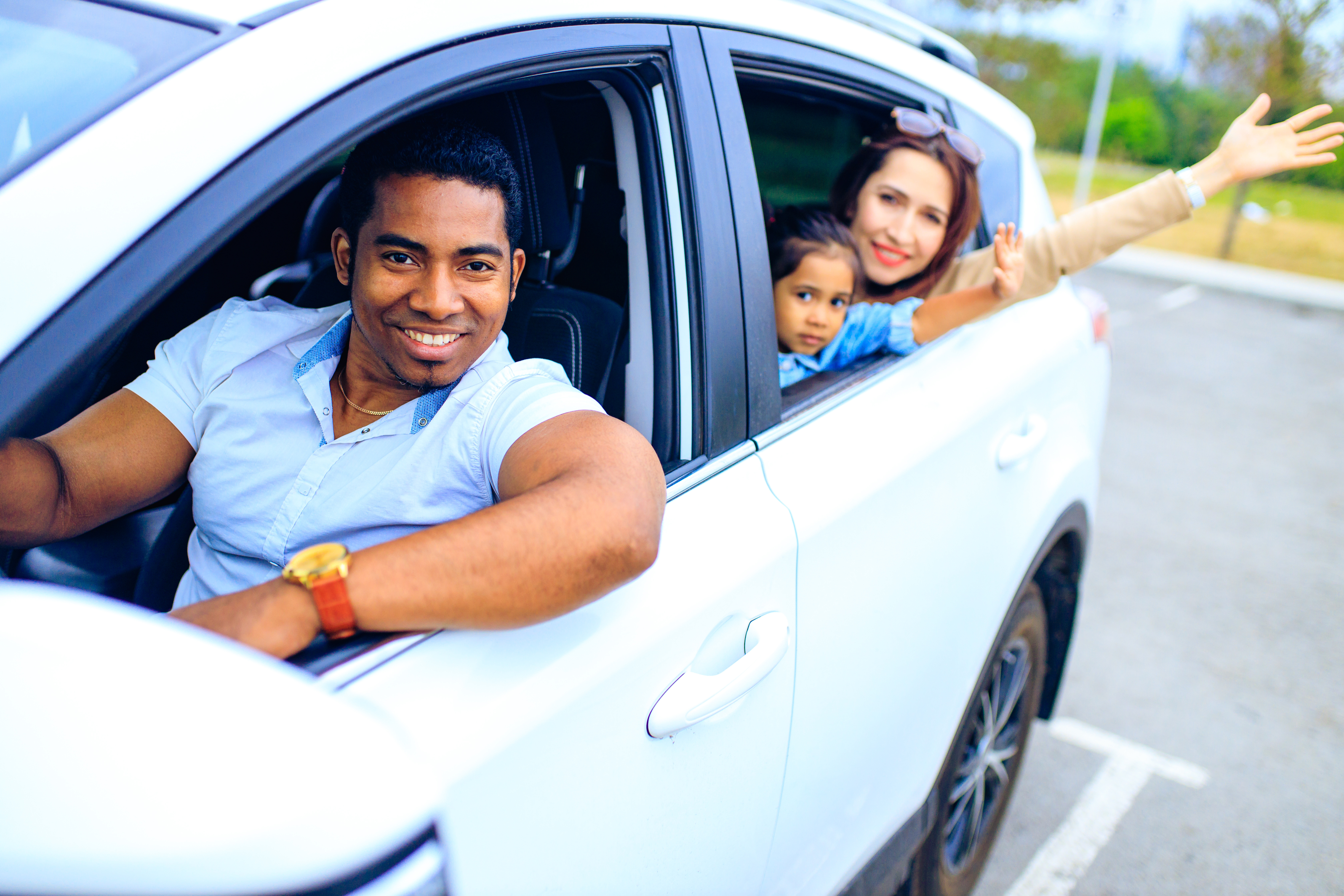 Family of 3 in their new car